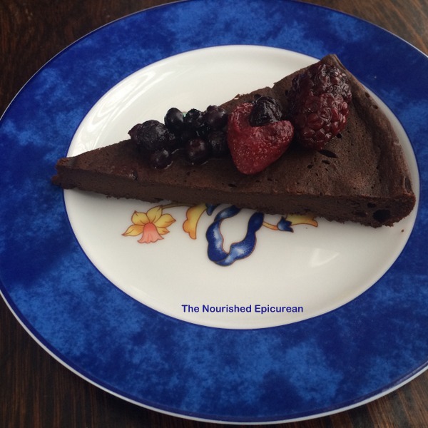Flourless chocolate cake topped with berries